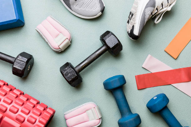 A collection of fitness accessories including resistance bands, dumbbells, and a water bottle. Essential tools for enhancing workout routines, building strength, and staying hydrated. Perfect for home or gym use.