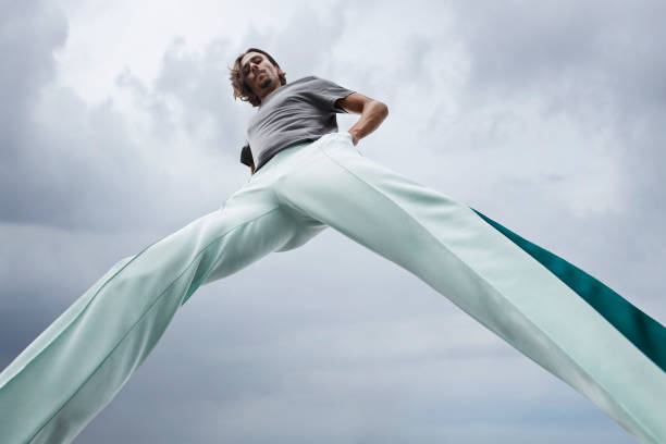 Men's pants displayed on a flat surface. The pants are a classic cut in a neutral color, with a straight-leg design and a waistband with belt loops.